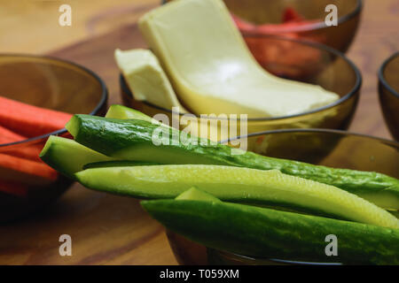 Ingredients for the preparation of sushi in plates on the table, which include pickled ginger, rice, cucumbers, melted cheese, top view 2019 Stock Photo