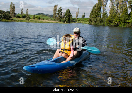 Kayaking, Father and daughter on kayak, Lake Farm bach, Taranaki, North Island, New Zealand Stock Photo