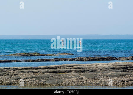 Paddle boarders on the waterfront at Huskisson, Jervis Bay, New South Wales, Australia Stock Photo