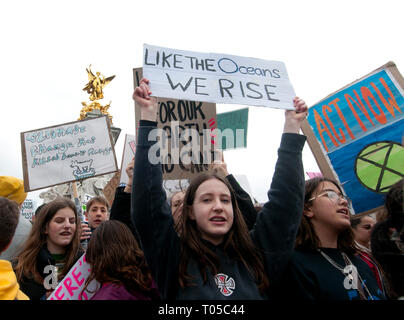 London. School students strike for climate change , part of a global action. A group take over the Victoria statue in front of Buckingham Palace. Stock Photo