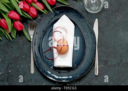 Beautiful festive table with flowers setting for Easter. Holidays background. Top view. Stock Photo