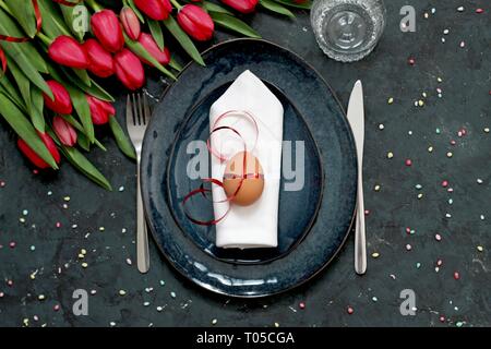 Beautiful festive table with flowers setting for Easter. Holidays background. Top view. Stock Photo