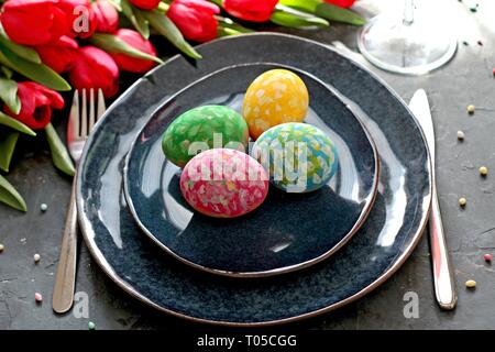 Beautiful festive table with flowers setting for Easter. Holidays background. Top view. Stock Photo