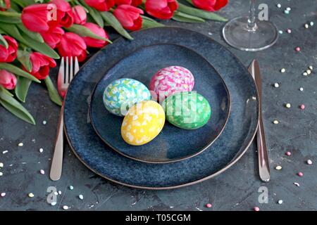 Beautiful festive table with flowers setting for Easter. Holidays background. Top view. Stock Photo