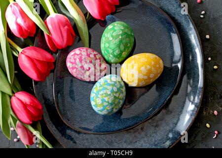 Beautiful festive table with flowers setting for Easter. Holidays background. Top view. Stock Photo