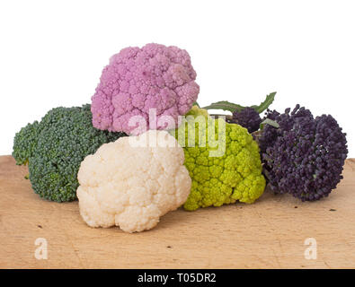 Colourful vegetables, white background. Assorted raw cauliflower, broccoli and purple sprouting florets. Healthy assortment. Stock Photo