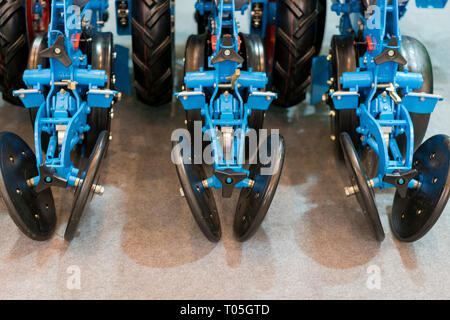 Corn harvester head with several silver blades. Agricultural machinery for soil cultivation. Stock Photo