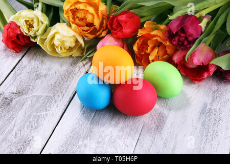 Festive table setting for Easter with colorful eggs and tulip on spring Stock Photo