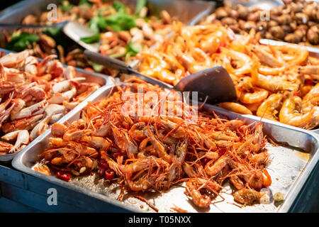 Fried shrimp in street food stall in Asian night market Stock Photo