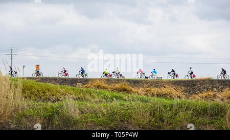 Group of cyclists on a Sunday trip along the Tiber near Rome Stock Photo