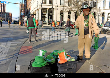 Cleveland, Ohio, USA, 17th March, 2019.  A vendor stands on a street corner in downtown Cleveland, Ohio, USA hawking St. Patrick's Day regalia to early morning revelers.  Credit: Mark Kanning/Alamy Live News. Stock Photo