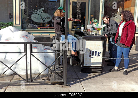 Cleveland, Ohio, USA, 17th March, 2019.  Employees prepare an early morning outdoor bar in anticipation of early morning St. Patrick's Day revelers.  Hundreds of thousands of celebrants take to the streets of downtown Cleveland, Ohio, USA during this rite of spring.  Credit: Mark Kanning/Alamy Live News. Stock Photo
