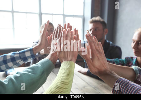Business people's palms clasped together, giving high five to each other, agreement, achievement, joining, progress, connect, deal concept Stock Photo