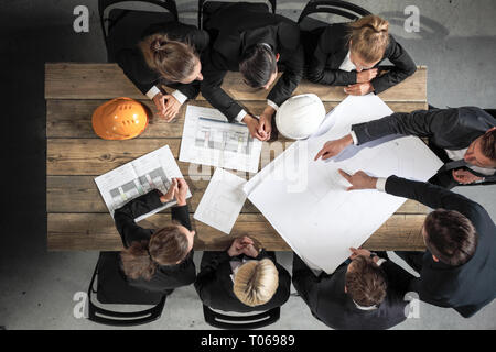 Engineers and businessmen are discussing construction projects in workplace. Construction concept. Stock Photo