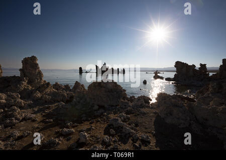 The morning sun over the South Tufa Area, Mono Lake, Mono County, California, America, with tufa towers in silhouette Stock Photo