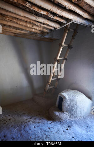 A clay oven below a ladder which led to the main entrance via the roof, which also allowed smoke out. A reconstruction of one of four Catalhoyuk house Stock Photo