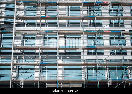 new building under construction scaffolding on house facade  - Stock Photo