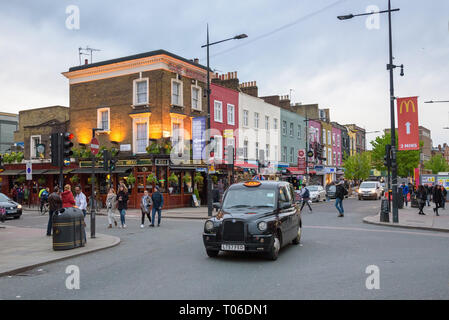 Camden Town, London, UK - April 30, 2018: People walk famous Camden High Street on a cloudy day Stock Photo