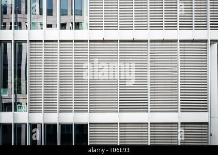 closed sun blinds on office building facade - real estate background Stock Photo