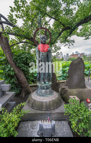 Taito-ku, Tokyo - July 27, 2017: Offerings placed at Monument of Jizo or Ksitigarbha.  Located in front of Shinobazu Bentendo temple, Ueno Park Stock Photo