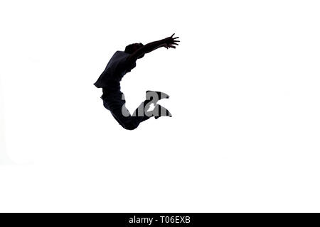 Silhouette of a young man who's doing breakdance Stock Photo
