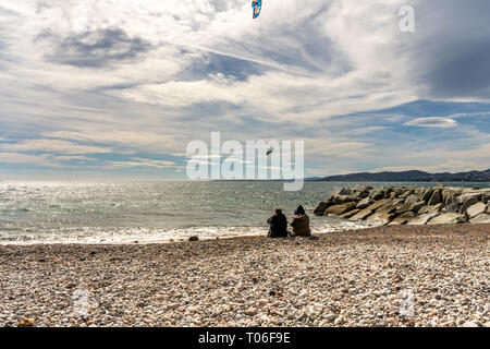 people watching a kite surfer in actionon french riviera in saint raphael, france Stock Photo