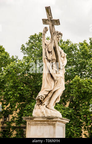 Angel with the Cross statue on Bernini's Bridge of Angels in Rome, Italy by Erocole Ferrata. Stock Photo