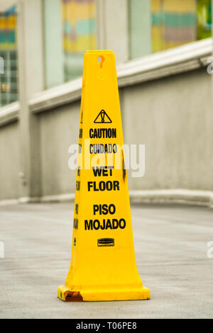 LAS VEGAS, NV, USA - FEBRUARY 2019: Large yellow cone warning pedestrians on the Las Vegas Strip of a wet floor. Stock Photo