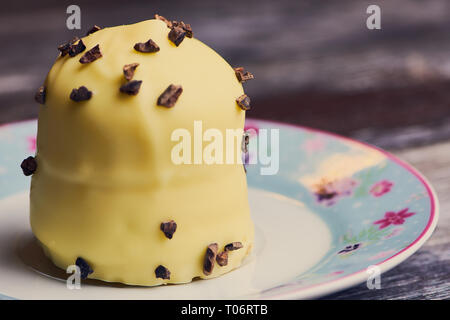 white chocolate covered marshmallow on a small plate on brown wooden surface Stock Photo