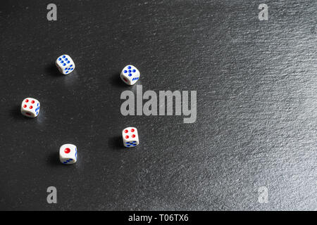 Life is a game concept.Dice on black background,gambling addiction. Stock Photo