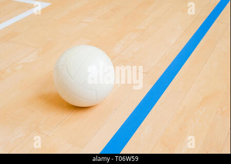 Volleyball ball on hardwood volleyball court Stock Photo