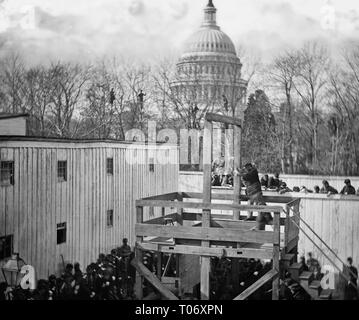 The execution of Henry Wirz, commandant of the (Confederate) Andersonville Prison, near the US Capitol moments after the trap door was sprung. Washington, D.C. Soldier springing the trap; men in trees and Capitol dome beyond, November 10, 1865 Stock Photo