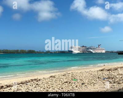 NASSAU, BAHAMAS--JANUARY 2018: Two luxury cruise ships are docked at the bay in Nassau on a bright sunny day seen from Junkanoo Beach Resort. Stock Photo