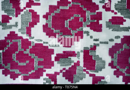 A fragment of ancient fabric with a beautiful pattern, made on a handmade loom. Stock Photo