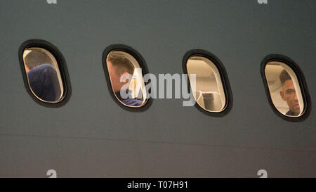 Glasgow, UK. 18th Mar, 2019. Liam Palmer (right window) onboard with the Scotland Football Team seen boarding their luxury jetliner private aircraft in the early hours seen at Glasgow Airport moments before departing for Kazakhstan to play a game on Wednesday. The flight was due to take off at 11pm, however due to an unforeseen problem where the pilot had to come out of the flight deck and onto the tarmac and speak with ground crew, the flight eventually took off in the early hours of today. Credit: Colin Fisher/Alamy Live News Stock Photo