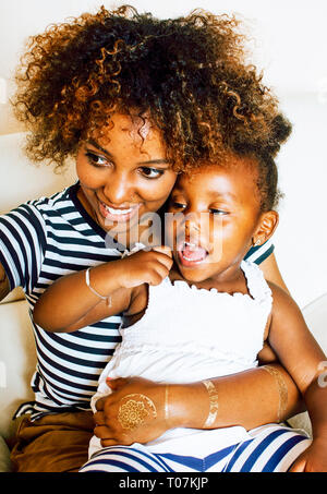 adorable sweet young afro-american mother with cute little daughter, hanging at home, having fun playing smiling, lifestyle people concept Stock Photo