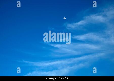 A waxing gibbous moon can be seen among cirrus clouds in California's North Bay. Stock Photo