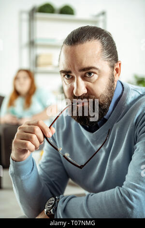 Serious therapist being deep in his thoughts Stock Photo
