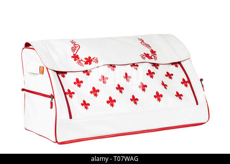 White-red leather bag with red print for storing things and traveling in the trunk of a car on a white isolated background. Luggage, handmade suitcase Stock Photo