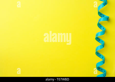 Folded centimeter ruler with measuring compartments on a yellow background. Craft and sewing concept. Copy space Stock Photo