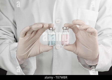 Doctor holding two vials Stock Photo