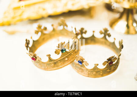 Golden crowns lying on the table in church Stock Photo