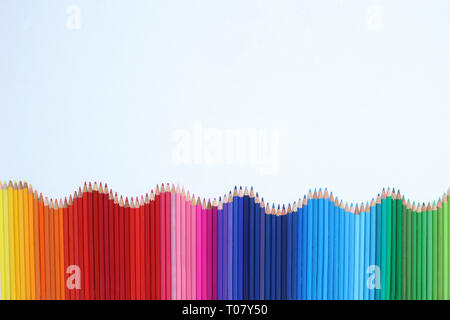 Rainbow of Pencils. A Wave of Coloured Pencils Isolated on a White Background Stock Photo