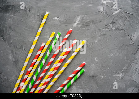 Paper straw of different colors on grey background with copy space Stock Photo