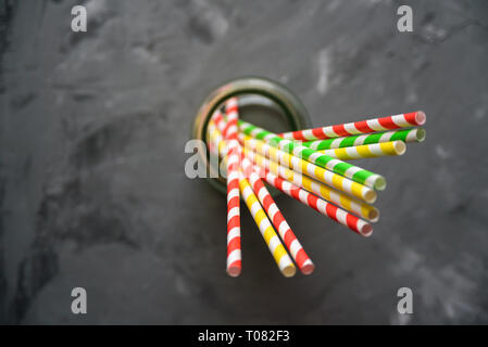 Paper straw of different colors on grey background with copy space Stock Photo