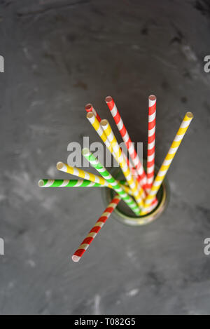 Paper straw of different colors on grey background with copy space Stock Photo