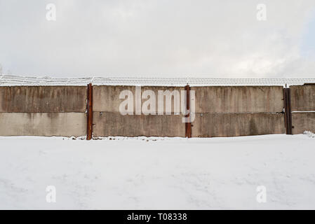 An area surrounded by dirty wired wall in winter. Stock Photo