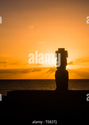 Moai shilouette in the Ahu Tahai during the sunset, Easter Island, Chile, South America Stock Photo