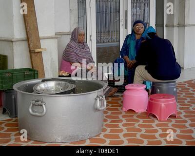 NEW DELHI, INDIA--MARCH 2018: Women takes a break from preparing meals for the devotees at the Gurdwara Bangla Sahib at Connaught Place. Stock Photo