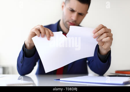 Disappointment business man tearing a sheet of white paper. Business failure concept Stock Photo